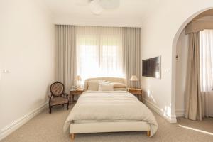 ein Schlafzimmer mit einem großen Bett und einem Fenster in der Unterkunft White House Swan Hill in Swan Hill