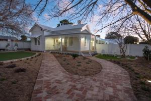 a white house with a brick driveway at White House Swan Hill in Swan Hill