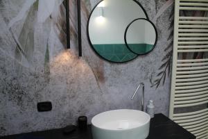 a bathroom with a sink and a mirror on the wall at Villa CliCla - Pool, sea,hommock swing and laziness in Imperia
