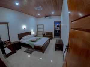 a bedroom with a bed and a wooden ceiling at Innovick Residence in Kandy