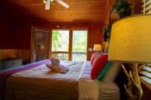 a bedroom with a bed with a stuffed animal on it at Smoky Waters Chalet in Sevierville