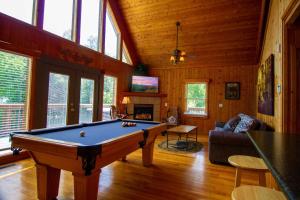 a living room with a pool table in a house at Smoky Waters Chalet in Sevierville