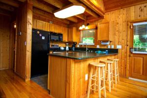 a kitchen with a black counter top and wooden cabinets at Smoky Waters Chalet in Sevierville
