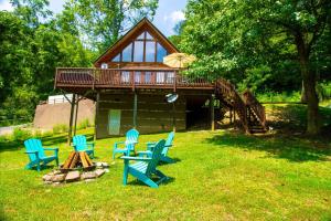 a house with three blue chairs and a deck at Smoky Waters Chalet in Sevierville