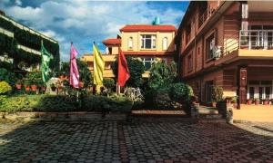 a group of flags in front of a building at Hotel Bedrock in Pokhara