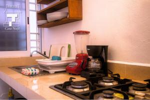 a kitchen counter with a blender on top of a stove at Najil House St1 in Bacalar