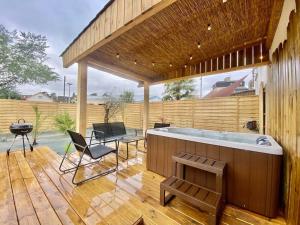a hot tub on a wooden deck with a patio at Le SPA de l’Impasse in Limoges