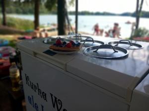 a counter top with a bowl of fruit on it at Pole namiotowe - namiot do wynajęcia - Kurka Wodna !!! in Mikołajki