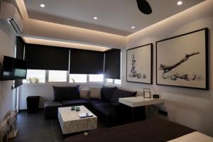 a living room with a couch and a table at Only2Suites in Athens