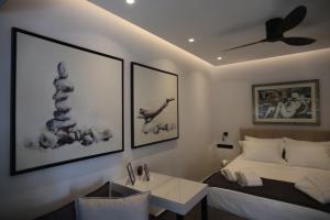 a bedroom with a bed and a ceiling fan at Only2Suites in Athens