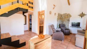 a living room with a staircase and a halloween pumpkin at Villa Sol Alozaina by Ruralidays in Alozaina