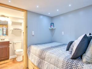 a blue bedroom with a bed and a toilet at Casey Paradise Tiny Home Mountain Retreat in Cullowhee