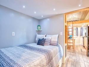 a bedroom with a bed and a wooden floor at Casey Paradise Tiny Home Mountain Retreat in Cullowhee