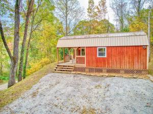 a red shed in the middle of a forest at Casey Paradise Tiny Home Mountain Retreat in Cullowhee