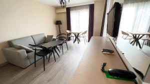 ein Wohnzimmer mit einem Sofa und einem Tisch mit einem Telefon in der Unterkunft Farrys Boutique Hotel & Beach Club - Yalıkavak in Yalıkavak