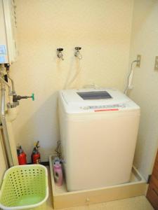 uma máquina de lavar roupa num canto de um quarto em Ueda Building - Vacation STAY 8563 em Asahikawa