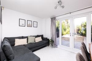 a living room with a couch and a sliding glass door at Coastal Retreat in Carmarthenshire in Llanelli