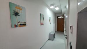 a hallway with white walls and a hallway with at Silver DeLux Apartman in Balatonfüred