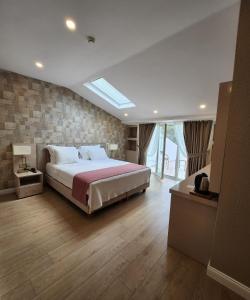 a bedroom with a large bed and a large window at Villa No 44 in Darıca