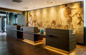 a lobby with a wall with a mural of animals at Motel One Manchester-Royal Exchange in Manchester