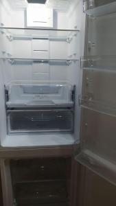 an empty refrigerator with its door open and a drawer at Σουίτα στην εξοχική βίλλα Δημήτριος Τάκης . in Ioannina