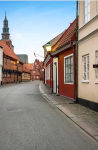 an empty street in a town with buildings at Rooms in the center of Ystad in Ystad