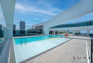 a swimming pool on the roof of a building at LUXE- 2BR With Sofabed Nordic Haven at 1 Residences Wasl 1 in Dubai