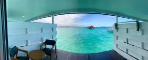 a view of the ocean from the balcony of a boat at Maglami-lami Water House in Semporna