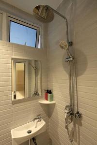 a white bathroom with a sink and a shower at New 新设计 新概念 Konzept House 2 Near Jonker@Heritage in Melaka