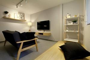 a living room with a couch and a television at New 新设计 新概念 Konzept House 2 Near Jonker@Heritage in Melaka