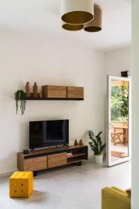 a living room with a flat screen tv on a wall at Zagara 139 in Ischia Town