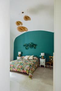 a bedroom with a bed and a blue wall at Zagara 139 in Ischia Town