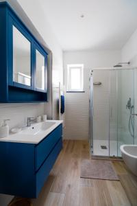 a bathroom with a blue sink and a shower at Zagara 139 in Ischia Town +7 photos