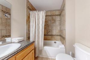 een badkamer met een bad, een wastafel en een toilet bij The Inn at Silvercreek 432 in Granby