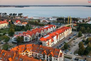 an aerial view of a city with buildings and the water at Apartament Pasaż in Giżycko