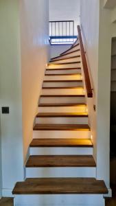 a stairway with wooden steps with lights on it at Amazing Sea & Mountain Duplex in Izmit in Izmit