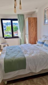 a bedroom with a large bed and a large window at Amazing Sea & Mountain Duplex in Izmit in Izmit