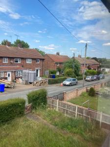 a view from a train window of a street with houses at Comfortable rooms upstairs at number 8 