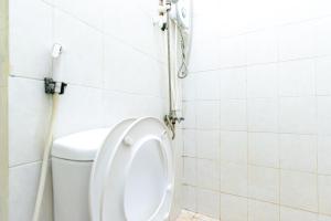 a bathroom with a toilet and a shower at RedDoorz near Kelapa Gading in Jakarta