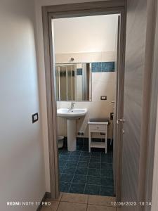 a bathroom with a sink and a mirror at Appartamenti Garda -Luna & Sole - in Garda