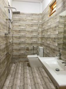 a bathroom with a toilet and a sink at The Reef Resort in Nilaveli