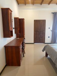a kitchen with a desk and cabinets in a room at The Reef Resort in Nilaveli