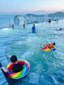 a group of people in the water in a swimming pool at The Song Yuki Apartment in Vung Tau