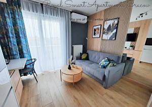 a living room with a couch and a table at Royal Smart Apartments Cracow in Krakow