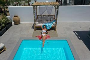 a model of a woman standing in a swimming pool at OLIVES seaside villas (4elies) in Plaka