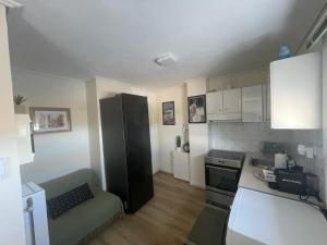 a small kitchen with a black refrigerator in a room at ParkSide Loft in Kalamata