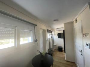 a living room with a table and a window at ParkSide Loft in Kalamata