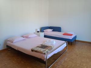 two beds sitting in a room withermottermott at Cube 1B Flat in Lugano