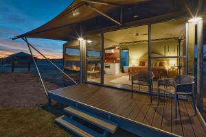 a house with a wrap around deck with a bedroom at Willow Wood Glamping Retreat in Broadwater