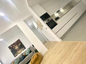 a living room with a staircase and a kitchen at Barcelona New Apartment- Free Parking- 10 min by metro from BCN Center and Sagrada Família in Barcelona